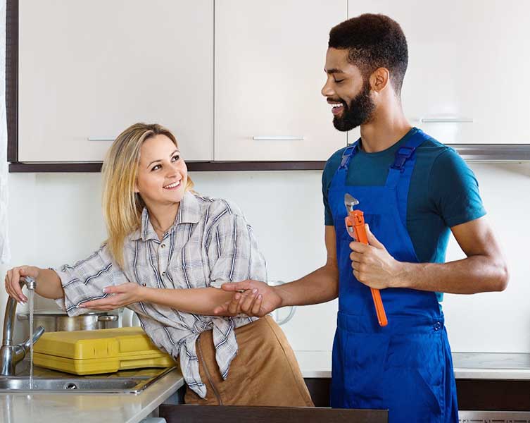 Technician repairing leaky pipes