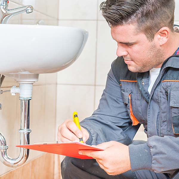 Man checking a sink pipe