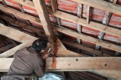 Man repairing roof leaks